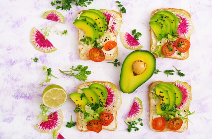 avocado sandwiches with radish rucola and tomatoes