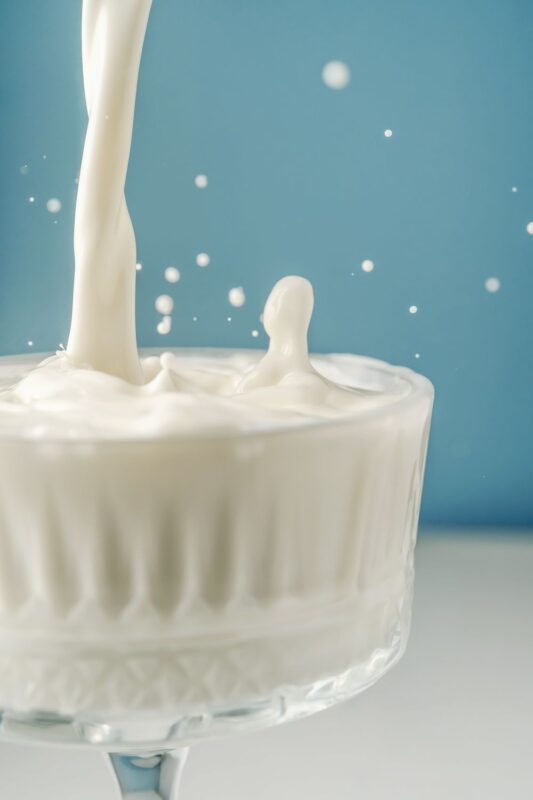 pouring milk in a small glass