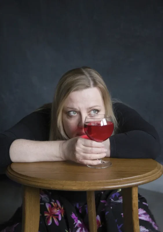 woman holding a glass of red wine