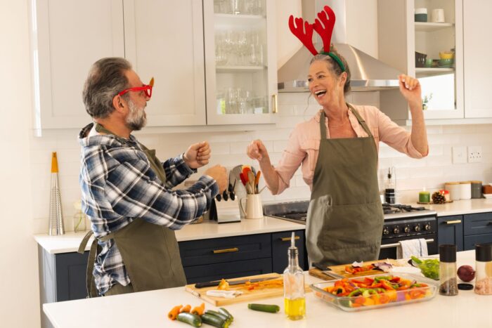 mature couple happily cooking healthy Christmas menu