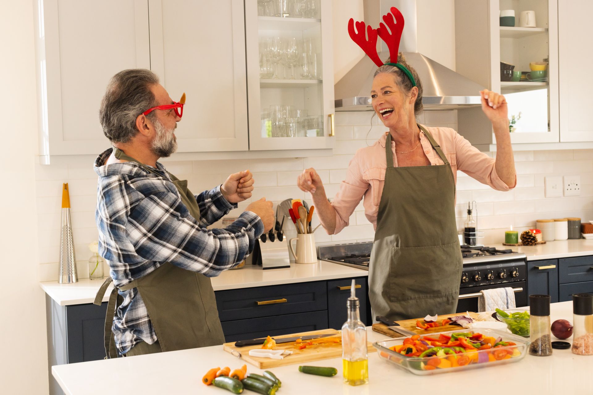 mature couple happily cooking healthy Christmas menu