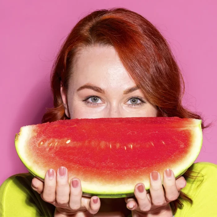 tasty watermelon slice held by a healthy woman